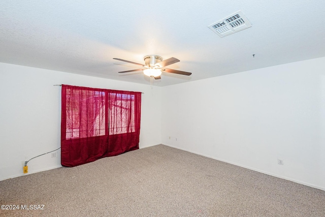 empty room featuring carpet floors and ceiling fan