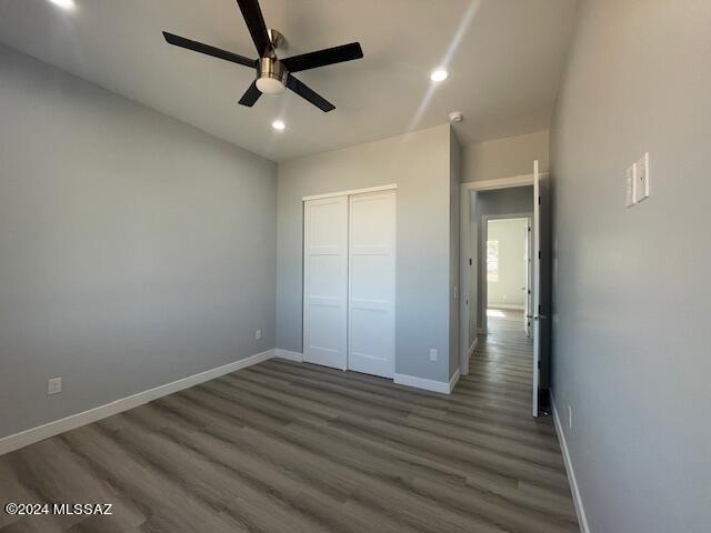 bathroom featuring toilet, vanity, baseboards, and wood finished floors