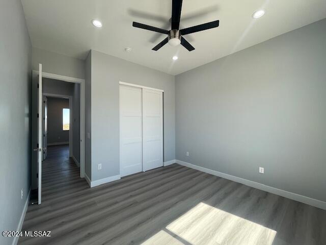 bathroom with hardwood / wood-style floors, a shower with shower door, and vanity