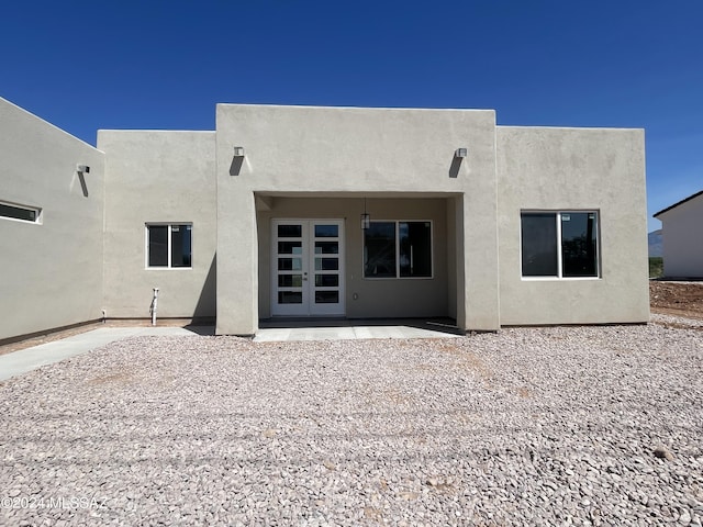 southwest-style home with a garage, concrete driveway, and stucco siding