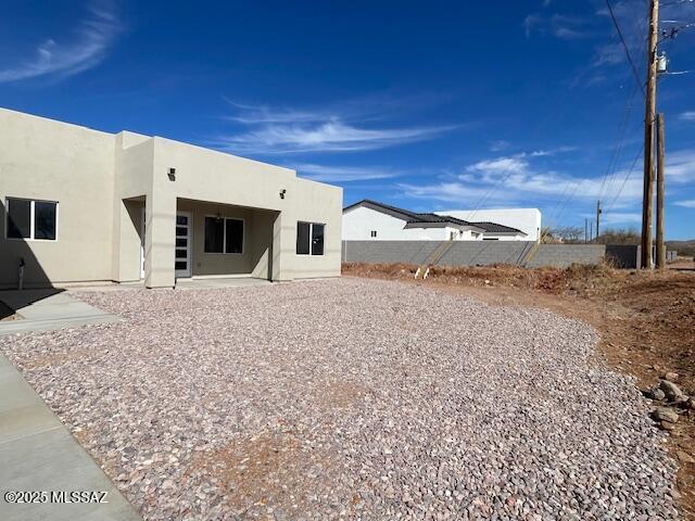 rear view of property featuring a patio area and stucco siding