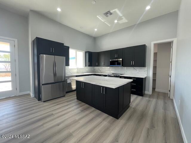 unfurnished living room with dark hardwood / wood-style flooring and a towering ceiling