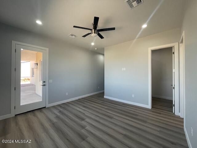 kitchen with dark cabinets, light countertops, appliances with stainless steel finishes, backsplash, and a center island