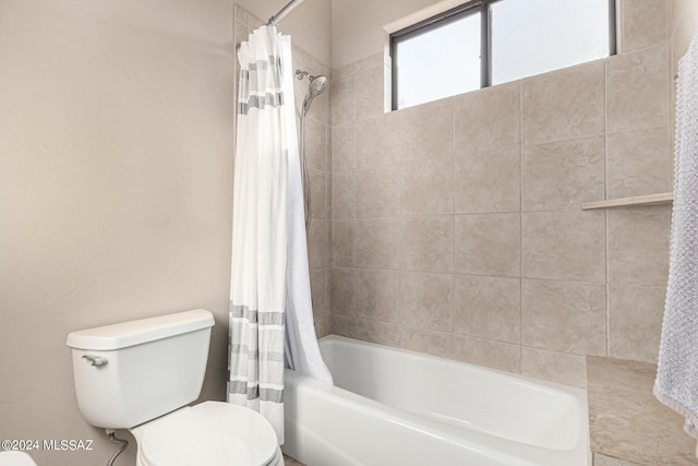 full bath featuring toilet and shower / tub combo with curtain