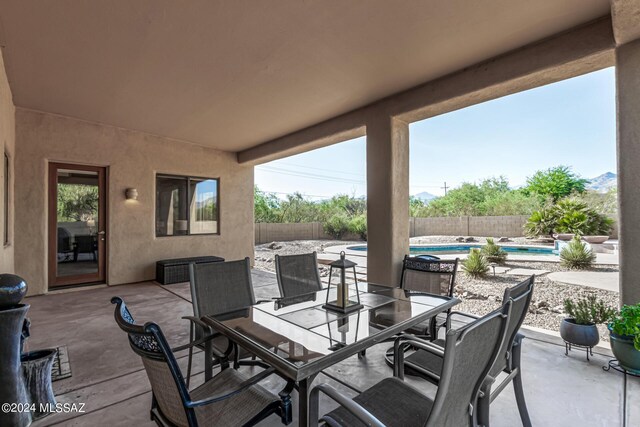 view of patio / terrace featuring a fenced backyard, outdoor dining area, and a fenced in pool