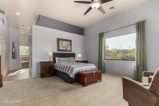 carpeted bedroom with ceiling fan and ensuite bath