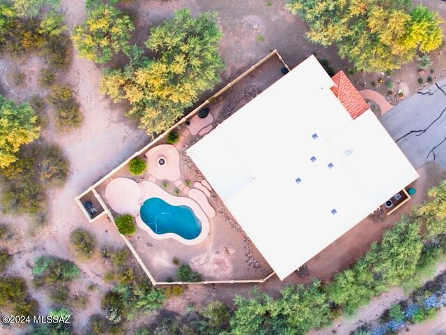 patio terrace at dusk featuring a fenced in pool, a fire pit, and a mountain view