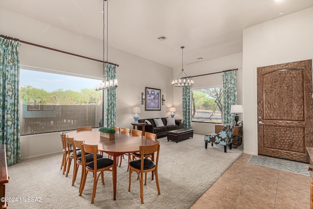 tiled dining area featuring an inviting chandelier