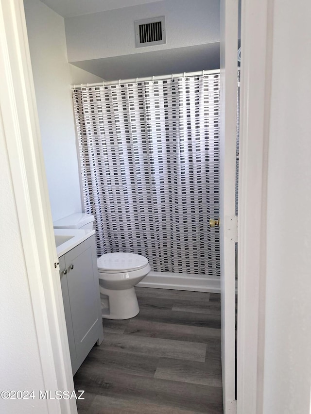 bathroom featuring hardwood / wood-style floors, vanity, and toilet