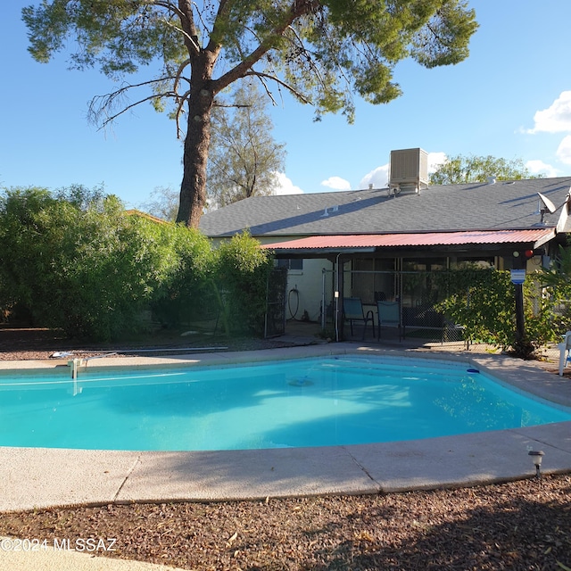 view of pool featuring a patio area and cooling unit