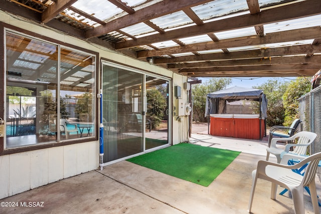 view of patio / terrace featuring a pergola and a hot tub