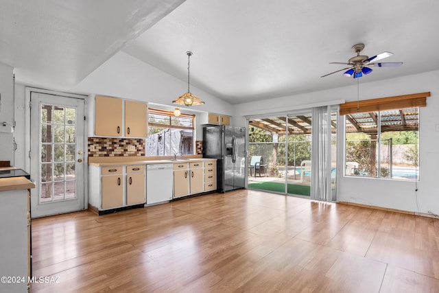 kitchen with stainless steel fridge, tasteful backsplash, white dishwasher, ceiling fan, and pendant lighting