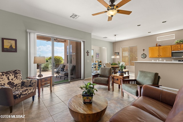 tiled living room featuring ceiling fan