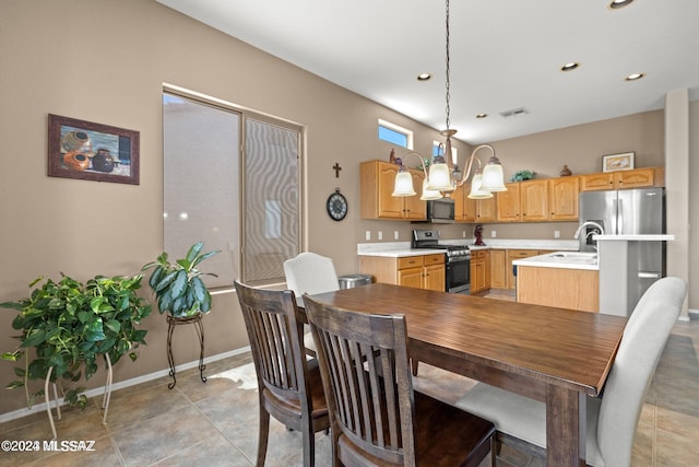 tiled dining area featuring a notable chandelier and sink