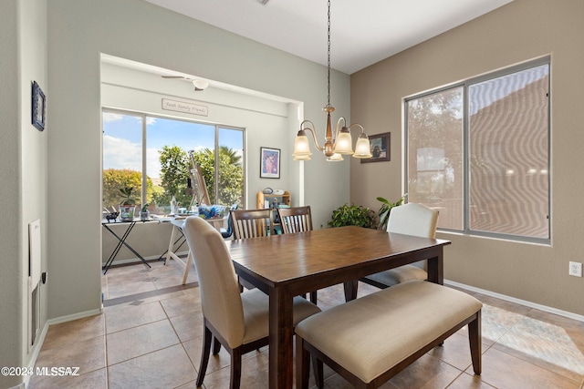 dining area with light tile patterned floors and a notable chandelier