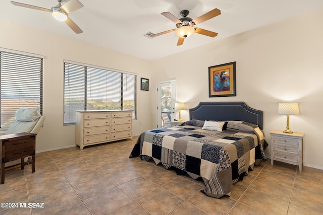 bedroom with ceiling fan and tile patterned flooring