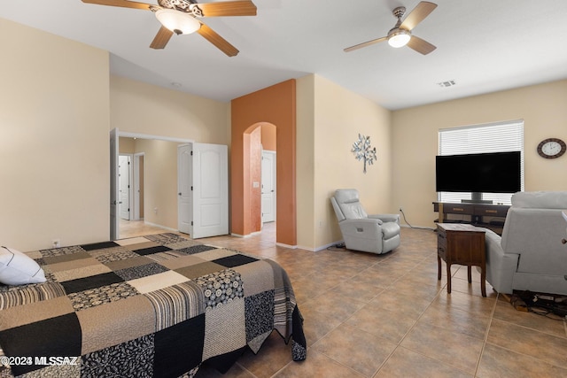 tiled bedroom with ceiling fan