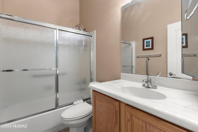 full bathroom featuring shower / bath combination with glass door, vanity, and toilet