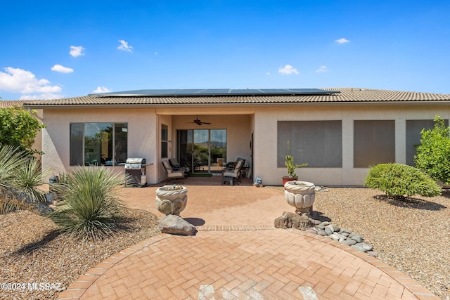 back of house featuring solar panels, ceiling fan, and a patio area