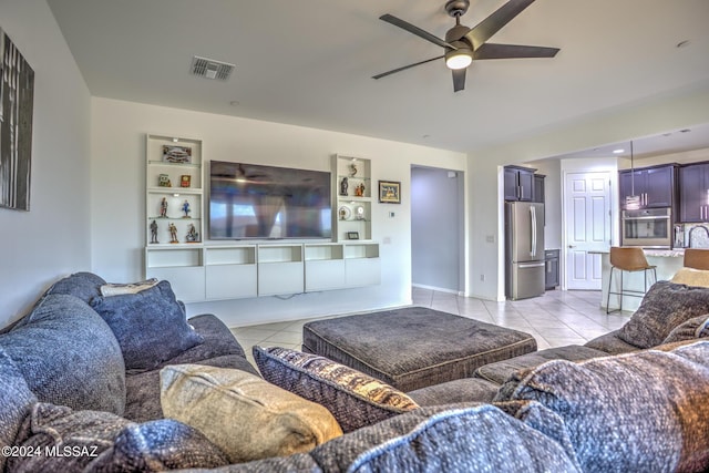 tiled living room featuring ceiling fan