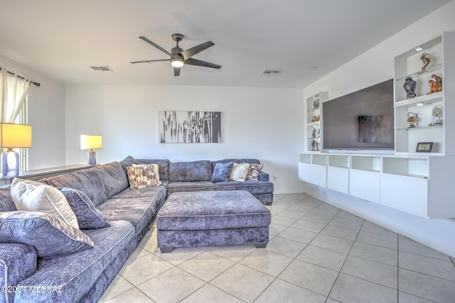 tiled living room featuring ceiling fan and built in features