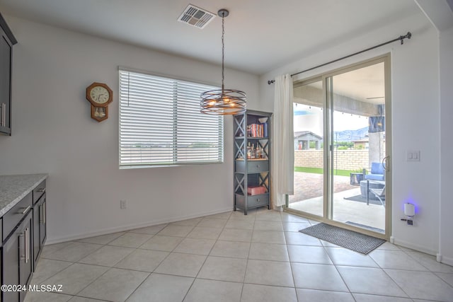 unfurnished dining area featuring light tile patterned flooring