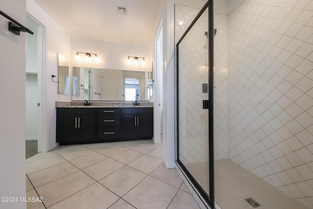 bathroom with vanity, an enclosed shower, and tile patterned flooring