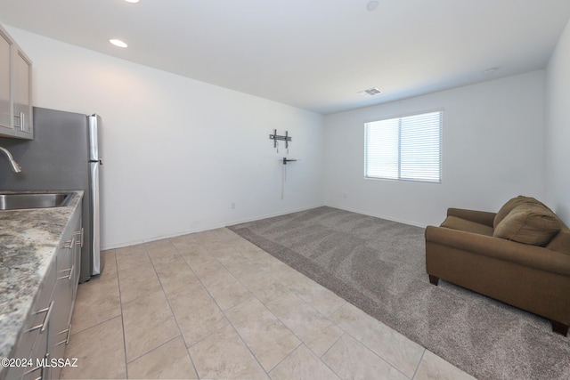 living area featuring sink and light tile patterned floors