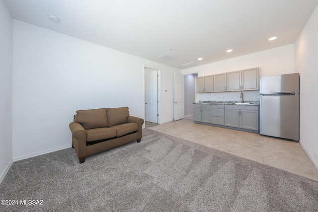 unfurnished room with sink and light colored carpet