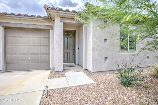 doorway to property with a garage