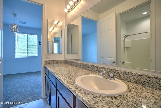 bathroom with vanity and walk in shower