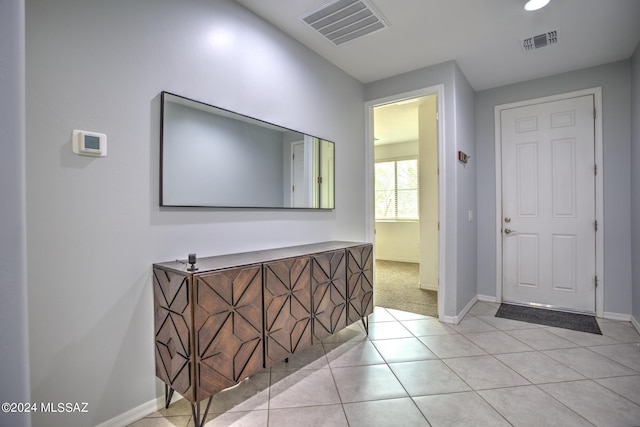 hallway featuring light tile patterned floors