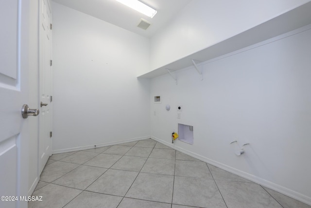 laundry area with gas dryer hookup, light tile patterned floors, hookup for a washing machine, and electric dryer hookup