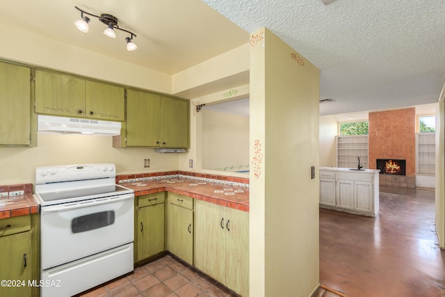 kitchen with sink, electric range, a fireplace, a textured ceiling, and butcher block countertops