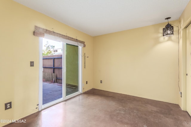 unfurnished room with concrete flooring