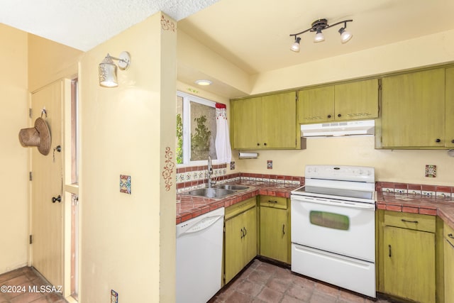 kitchen featuring tile countertops, sink, and white appliances