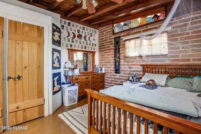 bedroom with brick wall, beam ceiling, and ceiling fan