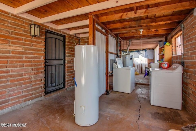 basement featuring water heater, gas water heater, independent washer and dryer, brick wall, and wooden ceiling