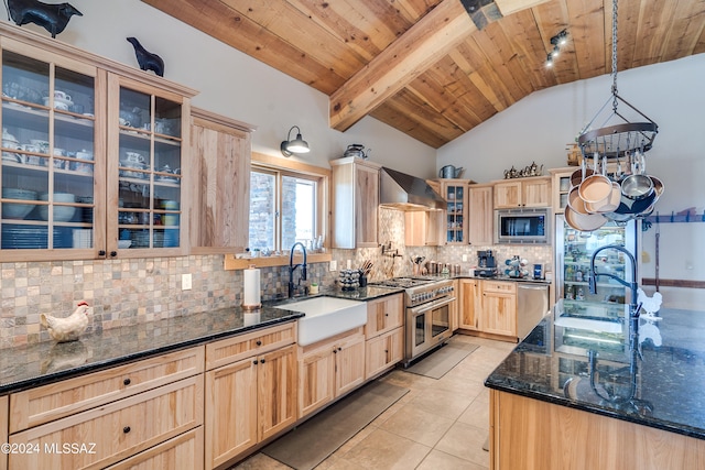 kitchen featuring sink, wall chimney range hood, tasteful backsplash, pendant lighting, and appliances with stainless steel finishes