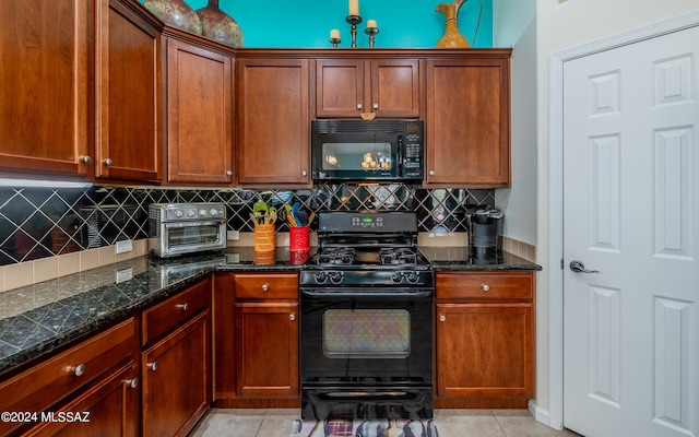 kitchen featuring light tile patterned flooring, decorative backsplash, dark stone counters, and black appliances