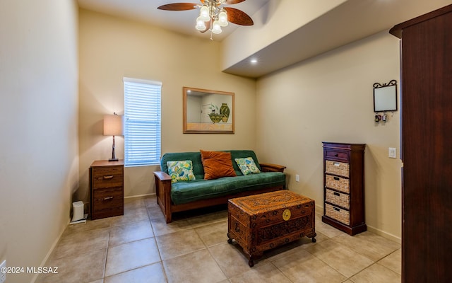 living area featuring ceiling fan and light tile patterned floors