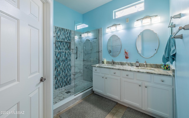 bathroom featuring tile patterned flooring, vanity, and a shower with shower door