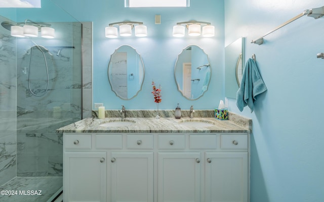 bathroom featuring tiled shower and vanity