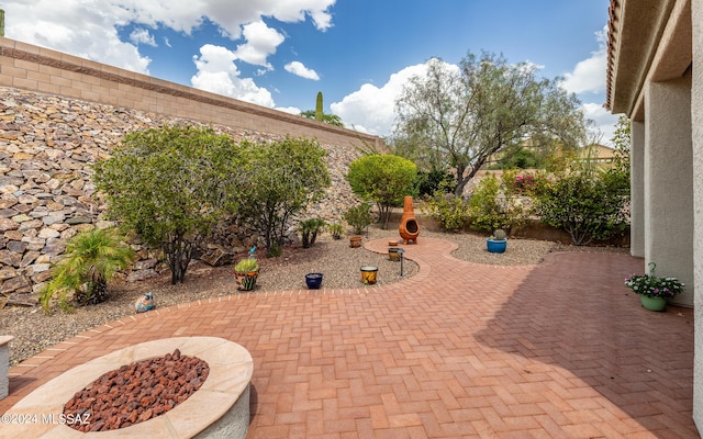 view of patio / terrace with an outdoor fire pit