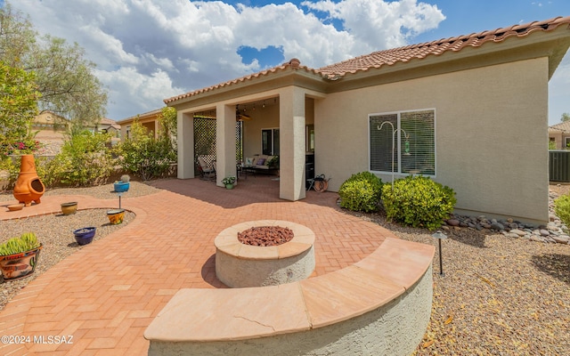 view of patio with central AC and an outdoor fire pit