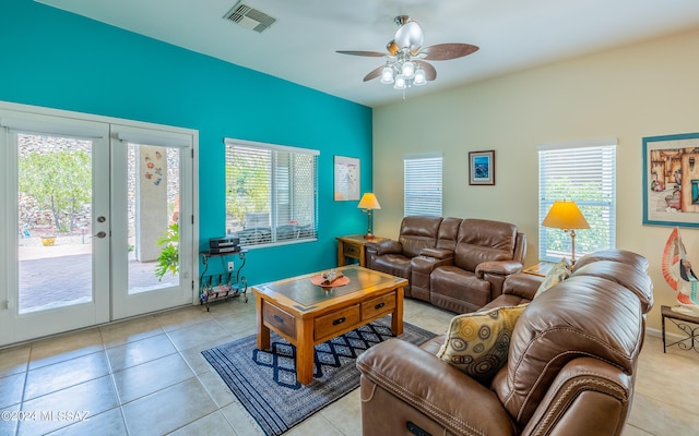 tiled living room with ceiling fan and french doors