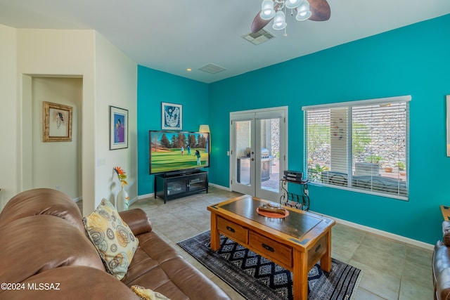 tiled living room with french doors and ceiling fan