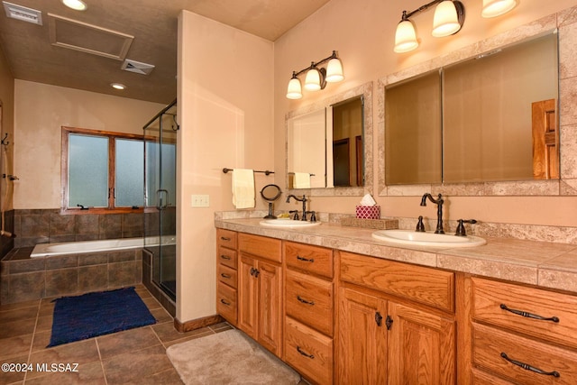 bathroom with tile patterned flooring, vanity, and shower with separate bathtub