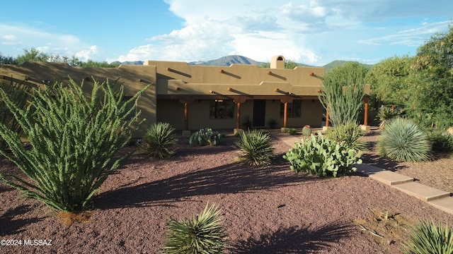 back of house with a mountain view