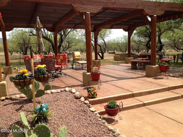 view of community featuring a pergola and a patio